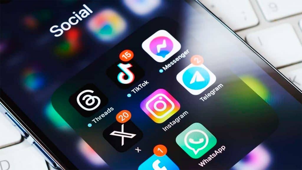 Pasta com ícones de redes sociais em tela inicial de iPhone
